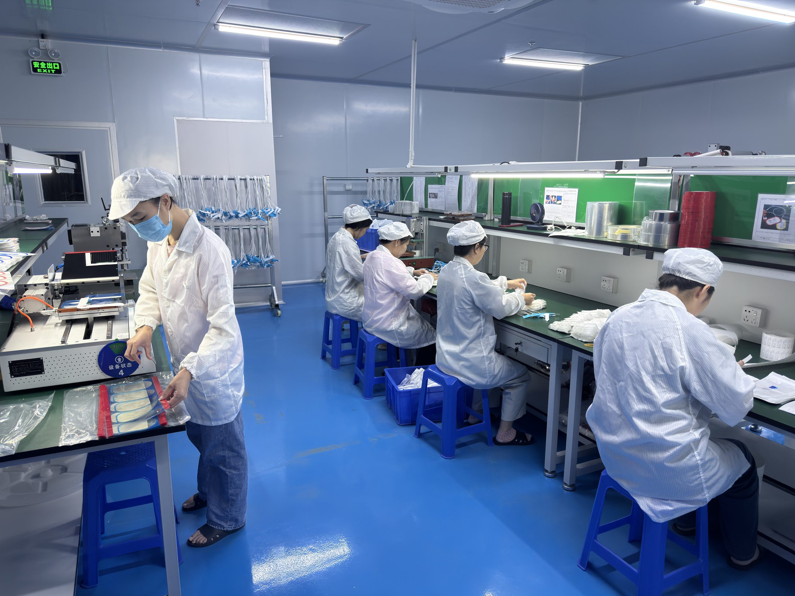 JYCMED technicians assembling medical cable components in a controlled workshop
